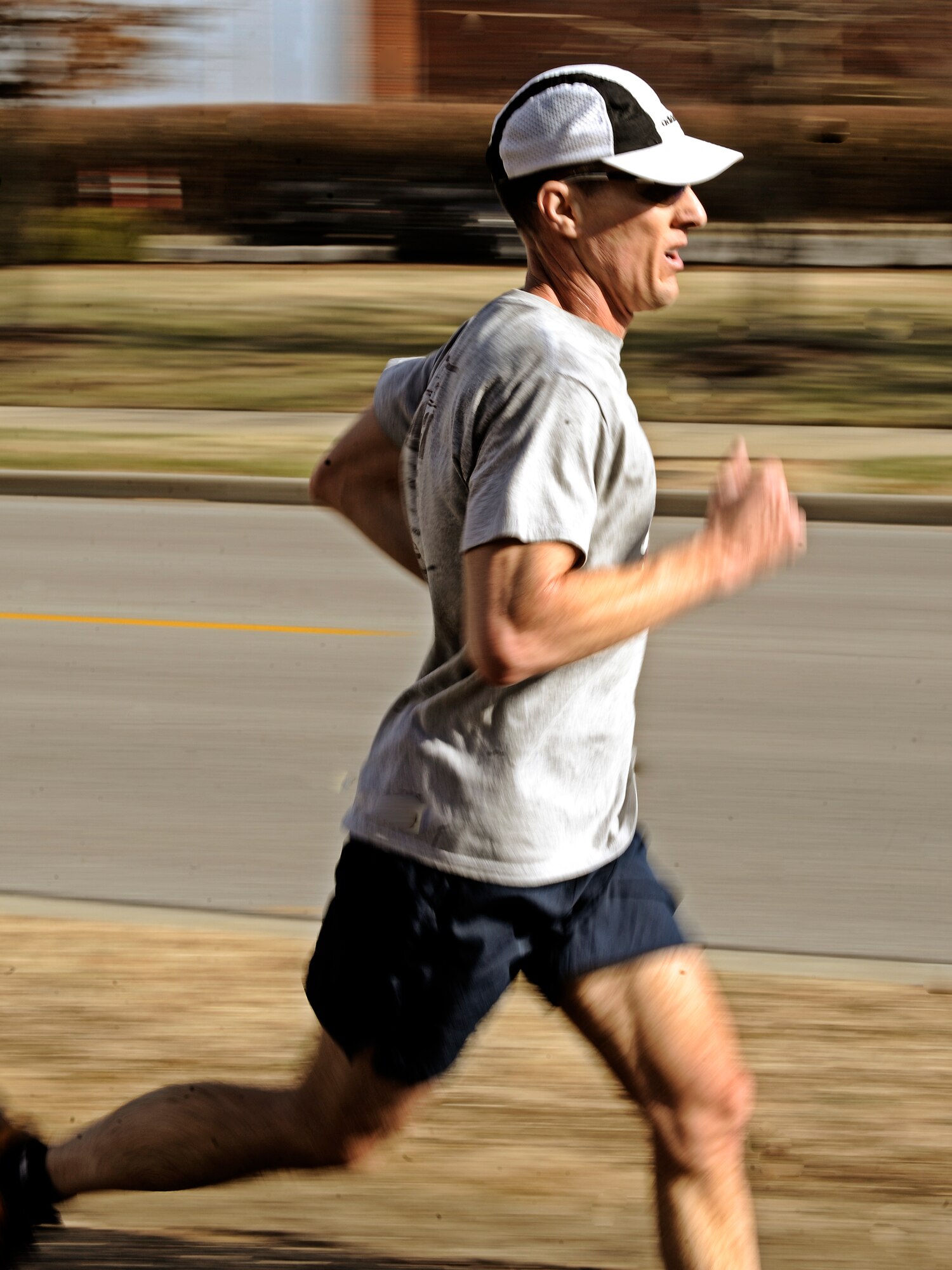 A runner sprints the last quarter of a mile to the finish line during the Holiday Frigid 5K Dec 10. More than 200 people participated in the event hosted by the 375th Force Support which was open to all members of Team Scott. (U.S. Air Force photo/ Staff Sgt. Ryan Crane)