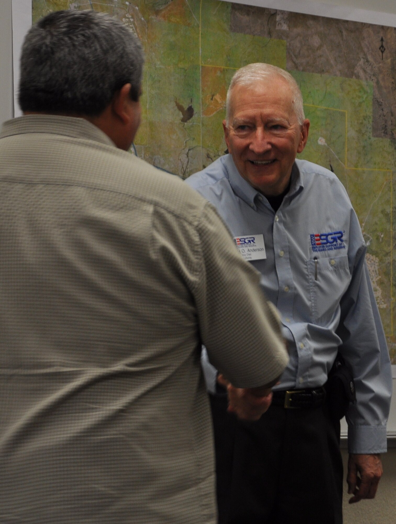 Robert Anderson, Vice Chair for Northern California Employer Support of the Guard and Reserve, greets an employer at the 940th Wing Employer Day, Nov. 5, 2010, at Beale Air Force Base, Calif.  The annual event provided community leaders and employers of Reservists an opportunity to explore the 940th Wing's missions and facilities. (U.S. Air Force photo/Tech. Sgt. Kenneth McCann)   