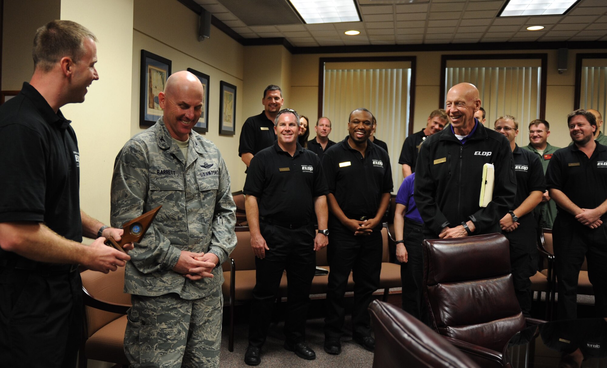 Col. Sam Barrett, 15th Wing commander, is presented with a "tip of the spear" on behalf of the Executive Leadership Development Program during a meeting at the 15th Wing Dec. 9. ELDP is a Secretary of Defense training initiative, sponsored by the Joint Staff, whose mission focus is meeting one of the department's top transformational priorities - leader development.  (U.S. Air Force Photo/Airman 1st Class Lauren Main)