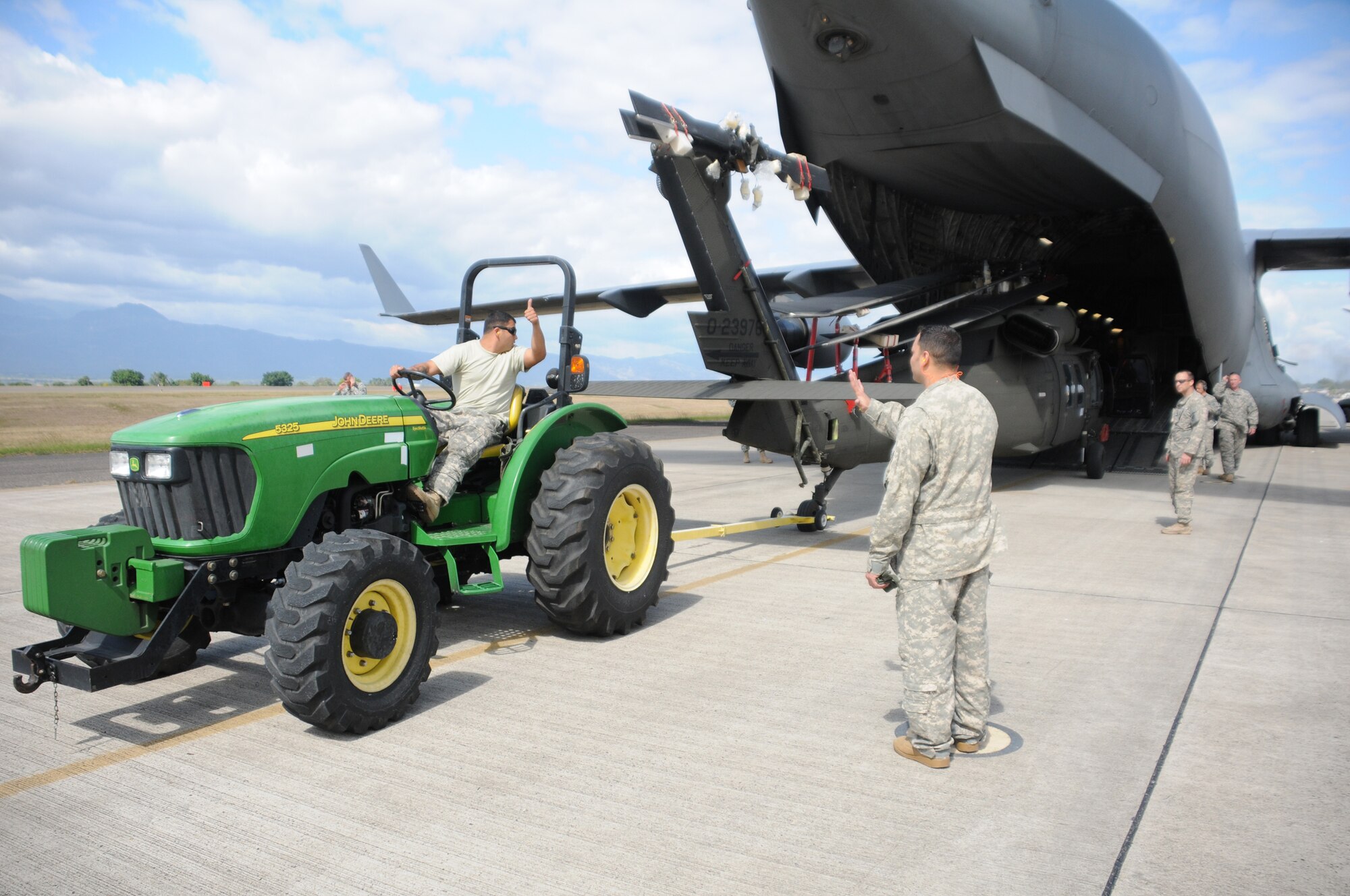 SOTO CANO AIR BASE, Honduras --  Members of the 1-228th Aviation Regiment prepare to transport a Black Hawk helicopter to their portion of the flightline here Dec. 9. The helicopter was delivered on board a C-17 Globemaster III, which came from McChord AFB, Wash. (U.S. Air Force photo/Tech. Sgt. Benjamin Rojek)