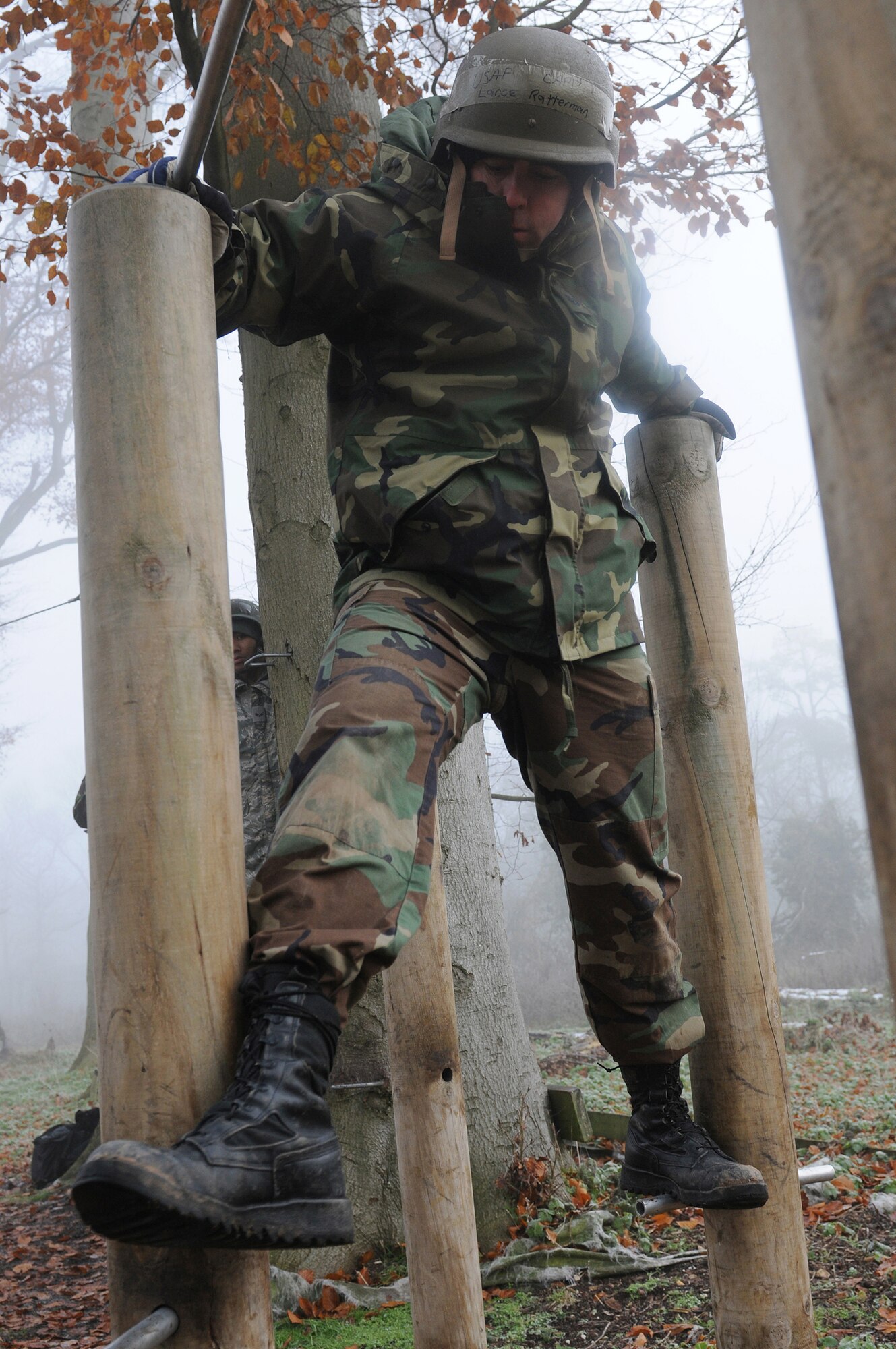Tech. Sgt. Travis Romesha crosses an obstacle at the low-ropes course during Leader, Ethos and Air Power Training Day Dec. 6, 2010, at Royal Air Force Marham, England. Activities of the day included paintball, target practice, a low-ropes challenge and a mind-over-matter exercise. Sergeant Romesha is a member of the 100th Air Refueling Wing Inspections and Readiness Office. (U.S. Air Force photo/Senior Airman Tabitha M. Lee)