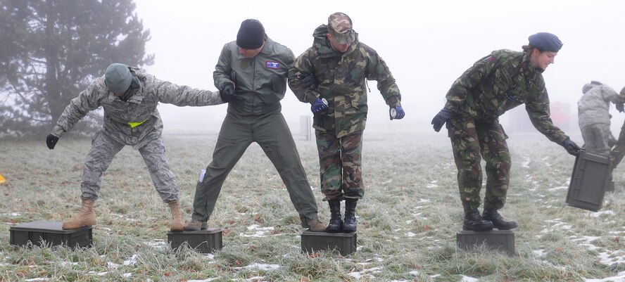 U.S. and Royal Air Force airmen from RAF Mildenhall, England, and RAF Marham, England, participate in a team building exercise during Leader, Ethos and Air Power Training Day Dec. 6, 2010, at RAF Marham. LEAP was conducted in a safe training environment, allowing participants to show individual character, spirit and attitude while facing physical and mental challenges. (U.S. Air Force photo/Senior Airman Tabitha M. Lee)