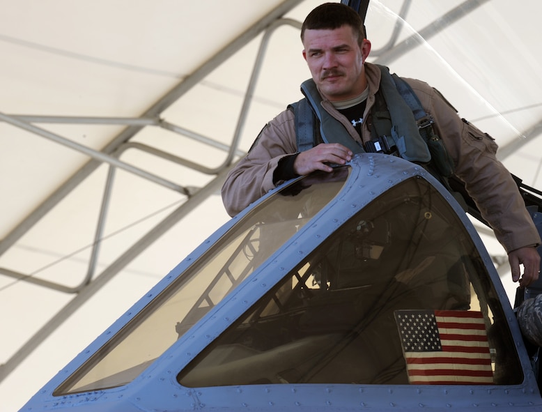 MOODY AIR FORCE BASE, Ga. -- Maj. Dennis Ott, 75th Fighter Squadron A-10C Thunderbolt II pilot, begins to exit his aircraft Dec. 9 after returning from his deployment to Afghanistan. Captain Shelly, along with three other A-10 pilots, returned safely after supporting Operation Enduring Freedom. (U.S. Air Force photo/Airman 1st Class Douglas Ellis) (RELEASED)