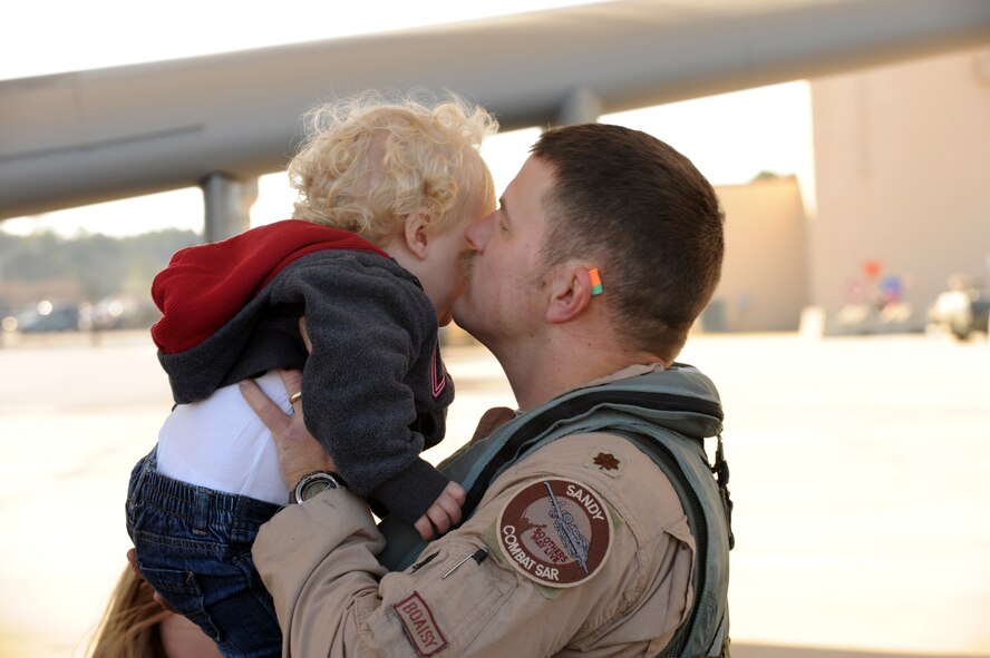 MOODY AIR FORCE BASE, Ga. -- Maj. Dennis Ott, 75th Fighter Squadron A-10C Thunderbolt II pilot, kisses his son, Vaughn, after returning from his deployment to Afghanistan Dec. 9. Major Ott and three other A-10 pilots were welcomed home by many friends, family and co-workers. (U.S. Air Force photo/Airman 1st Class Douglas Ellis) (RELEASED)