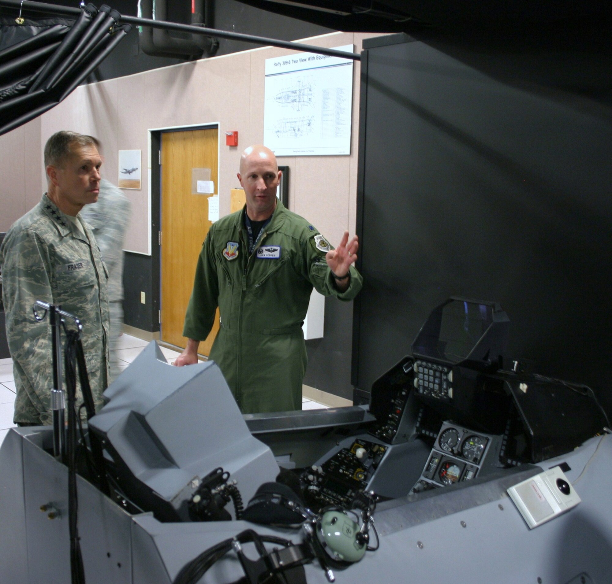Lt. Col. Daniel Pepper explains to Gen. William M. Fraser III the benefits the Distributed Mission Operations Center provides Dec. 7, 2010, at Kirtland Air Force Base, N.M. General Fraser toured the DMOC prior to the start of Virtual Flag 11-1. The exercises are conducted four times a year, with one dedicated to coalition warfare. Colonel Pepper is the 705th Combat Training Squadron commander and General Fraser III is the Air Combat Command commander. (U.S. Air Force photo/Tech. Sgt. Sidney Wells)