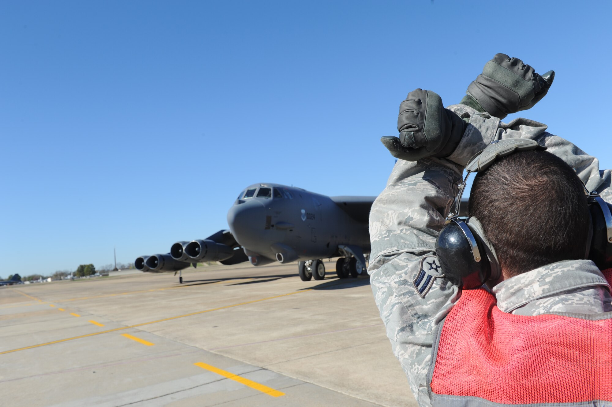 Airman 1st Class Matthew Cocran, a crew chief with the 2nd Maintenance Squadron, signals to the pilot before takeoff of a B-52H Stratofortress aircraft at Barksdale Air Force Base, La., Dec. 1. (U.S. Air Force photo by Staff Sgt. Chad Trujillo/Released)