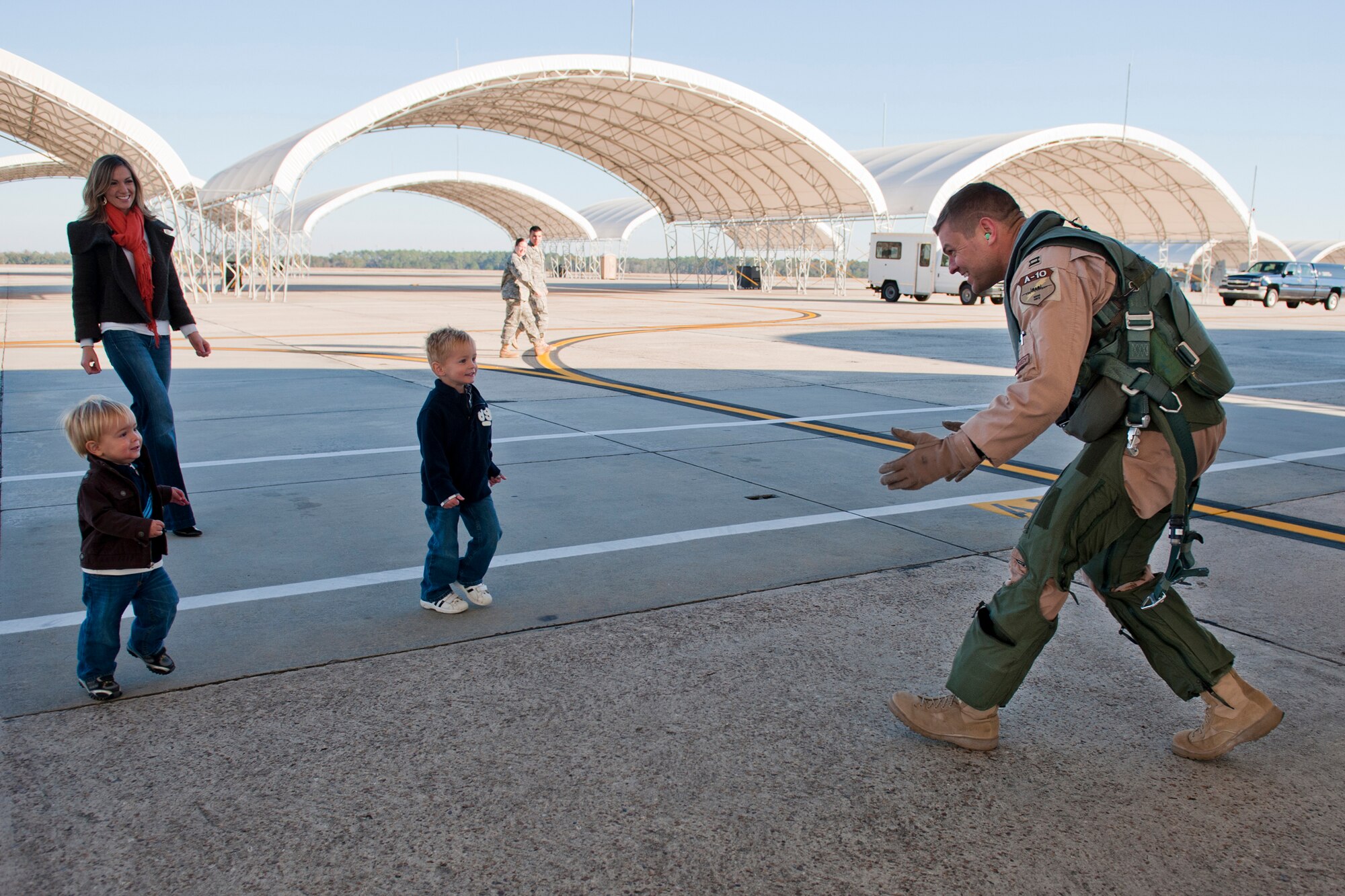 MOODY AIR FORCE BASE, Ga. -- Capt. David Befort, 75th Fighter Squadron A-10C Thunderbolt II pilot, embraces his family after returning from deployment Dec. 9. During his deployment, Captain Befort supported Operation Enduring Freedom in Afghanistan.  (U.S. Air Force photo/Senior Airman Jamal D. Sutter)(RELEASED)