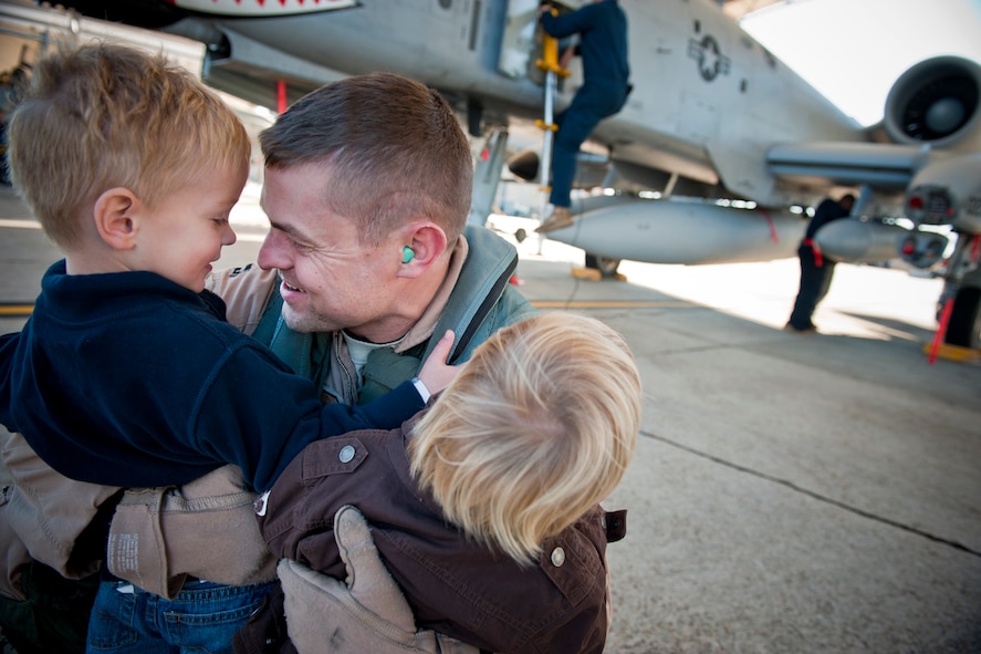 MOODY AIR FORCE BASE, Ga. -- Capt. David Befort, 75th Fighter Squadron A-10C Thunderbolt II pilot, hugs his sons, Jack and Beau, after returning from deployment Dec. 9. Captain Befort returned from Afghanistan with three other pilots from the 75th FS. (U.S. Air Force photo/Senior Airman Jamal D. Sutter)(RELEASED)