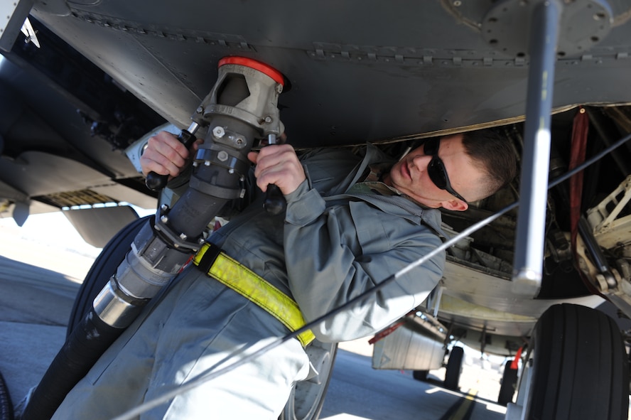 Senior Airman Chris Fitzgerald, a crew chief with the 20th Aircraft Maintenance Unit, hooks up a fuel hose to a B-52H Stratofortress aircraft at Barksdale Air Force Base, La., Dec. 1. (U.S. Air Force photo by Staff Sgt. Chad Trujillo/Released) 