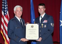 Lt. Gen. Thomas Owen, Aeronautical Systems Center commander, Wright-Patterson AFB, Ohio, and Staff Sgt. Scott Lilley, a security forces specialist with the 343rd Training Squadron, display his retirement certificate. General Owen officiated over Sergeant Lilley's retirement ceremony Dec. 2 at the Gateway Club. Sergeant Lilley, who medically retired after 11 years of active duty service, was seriously wounded in April 2007, while assigned to train local police forces in Iraq. Despite severe head wounds and bleeding, he continued to man his post while under attack. He was awarded the purple heart for his actions. Sergeant Lilley officially retires Dec. 23. (U.S. Air Force photo/Robbin Cresswell)