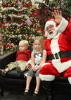 Tristan and Lexi Riley, children of Tech. Sgt. Kenneth Riley, 342nd Training Squadron, have their photo taken with Santa during the Children's Holiday Party Dec. 4. (U.S. Air Force photo/Robbin Cresswell)