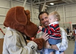 McGruff the Crime Dog greets James Shappell, a civilian employee with the 344th Training Squadron, and his son, Josh, during the Lackland Children's Holiday Party. The base-wide event was held Dec. 4 at the 344th TRS. (U.S. Air Force photo/Robbin Cresswell)