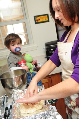Jessica Kelly, wife of Staff Sgt. Patrick Kelly, 2nd Civil Engineer Squadron plumber, makes cookies with the help of their son Jody, 1, at her home Dec. 6. Mrs. Kelly provided baked goods for the dorm cookie drive to help boost morale of dorm residents during the holiday season. (U.S. Air Force photo/Senior Airman Joanna M. Kresge)