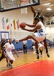 Lackland's Damion Turner looks to pass to Chris Grimmsley cutting toward the basket during the tournament championship against Fort Bliss Dec. 5. (U.S. Air Force photo/Robbin Cresswell) 