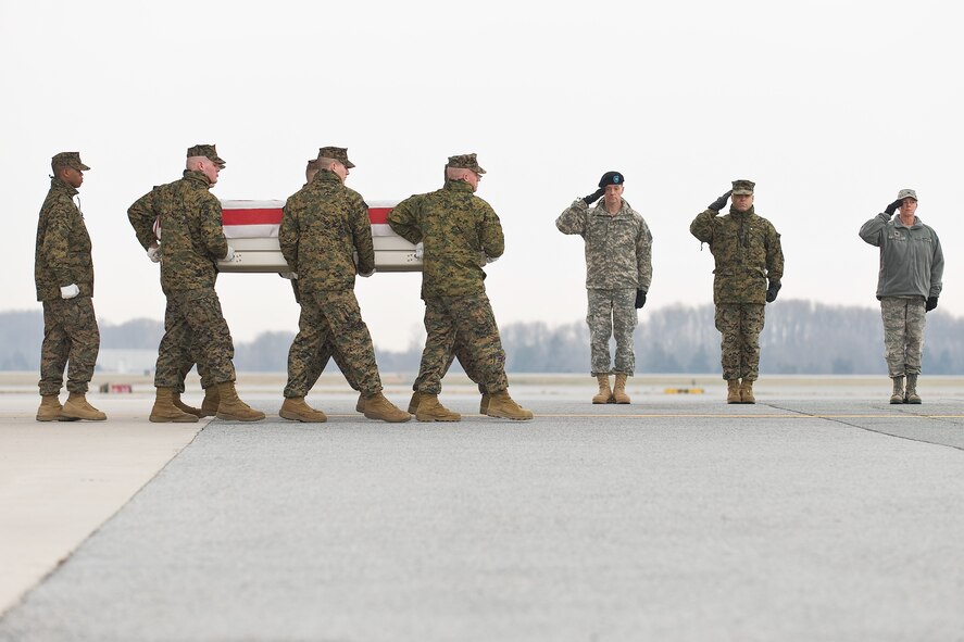 A U.S. Marine Corps carry team transfers the remains of Marine Lance Cpl. Michael E. Geary, of Derry, N.H., at Dover Air Force Base, Del., Dec. 10, 2010. Geary was assigned to the 2nd Battalion, 9th Marine Regiment, 2nd Marine Division, II Marine Expeditionary Force, Camp Lejeune, N.C.  (U.S. Air Force photo/Roland Balik)