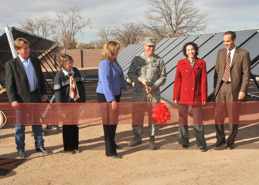 Glenn Gallipoli (from left), of the company 310 Solar; Sarah Cobb, representing Sen. Tom Udall; Christy Smith, 377th Mission Support Group Civil Engineer Division, Chugach Task Order Project Manager; Col. Robert L. Maness, 377th Air Base Wing commander; Jessica Perez, representing Sen. Jeff Bingaman; and, Antonio Sandoval, staff member for Rep. Martin Heinrich, attend the Dec. 3, 2010, ribbon-cutting ceremony for the new solar thermal system at Kirtland's indoor pool. (Courtesy photo)
