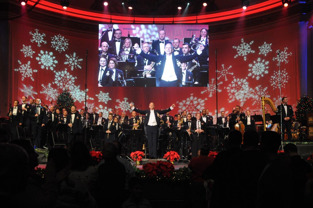 Lt. Col. A. Phillip Waite, commander and conductor of The United States Air Force Band, acknowledges the audience's applause during one of the Band's holiday concerts at DAR Constitution Hall. For this year's performances, the Concert Band, Singing Sergeants, and Ceremonial Brass joined forces to offer over 10,000 attendees "The Best Gift of All." (U.S. Air Force photo by Senior Airman Christopher Ruano)