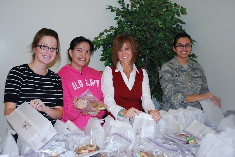 As part of the Patrick AFB Annual Cookie Drive, several thousand cookies were locally baked, packaged and then readied for delivery to dorm residents here, and mailed to troops deployed overseas. Dozens of people from the 45th Space Wing and our mission partners helped out, including (left to right) Caroline Dixon, Louella Kordgien, Lisa Wilson, wife of Brig. Gen. Ed Wilson, commander, 45th Space Wing, and Airman 1st Class Anna Diego of the 45th Medical Group.