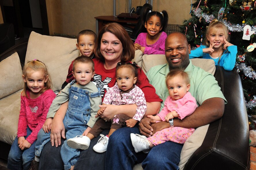 Lawrence and Allison Holt with their children, from left, Holly, Jace, Josh, Lexi, Sidney, Maci and Katie. The Holts, who were recently named the Oklahoma Department of Human Services Adoptive Parents of the Year, have adopted their seven children, ranging in age from 10 months to 6 years, within the last five years. (Air Force photo by David Faytinger)