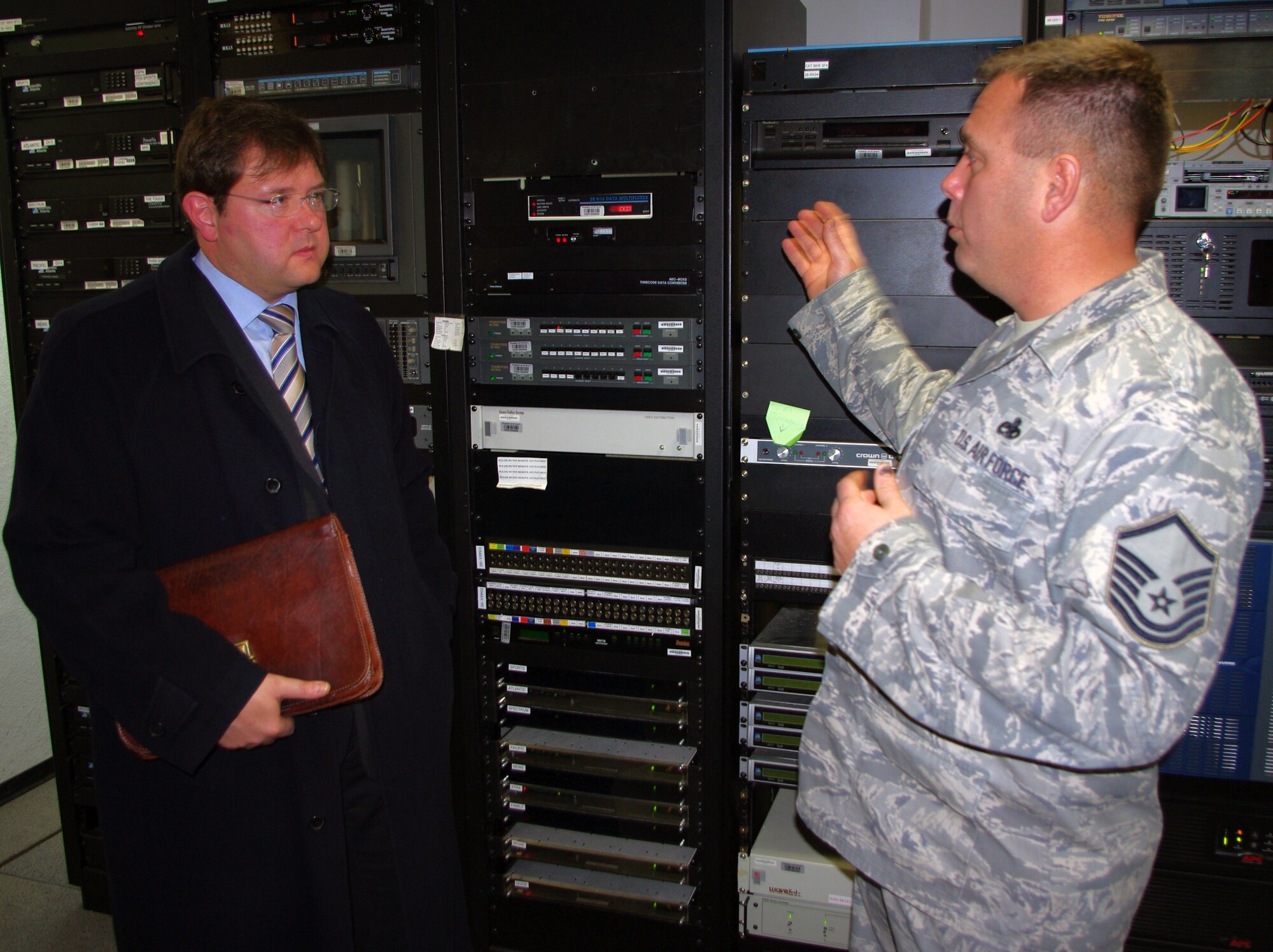 BITBURG, Germany -- Master Sgt. Clifton King, American Forces Network-Spangdahlem maintenance manager, provides a short tour of the broadcasting station to Mr.Joachim Kandels,  Bitburg mayor, after he talked for about 30 minutes about events and activities in the Bitburg area. He emphasized U.S. servicemembers and their families are always welcome. The AFN station is currently located on the Bitburg French caserne. (U.S. Air Force photo/Iris Reiff)