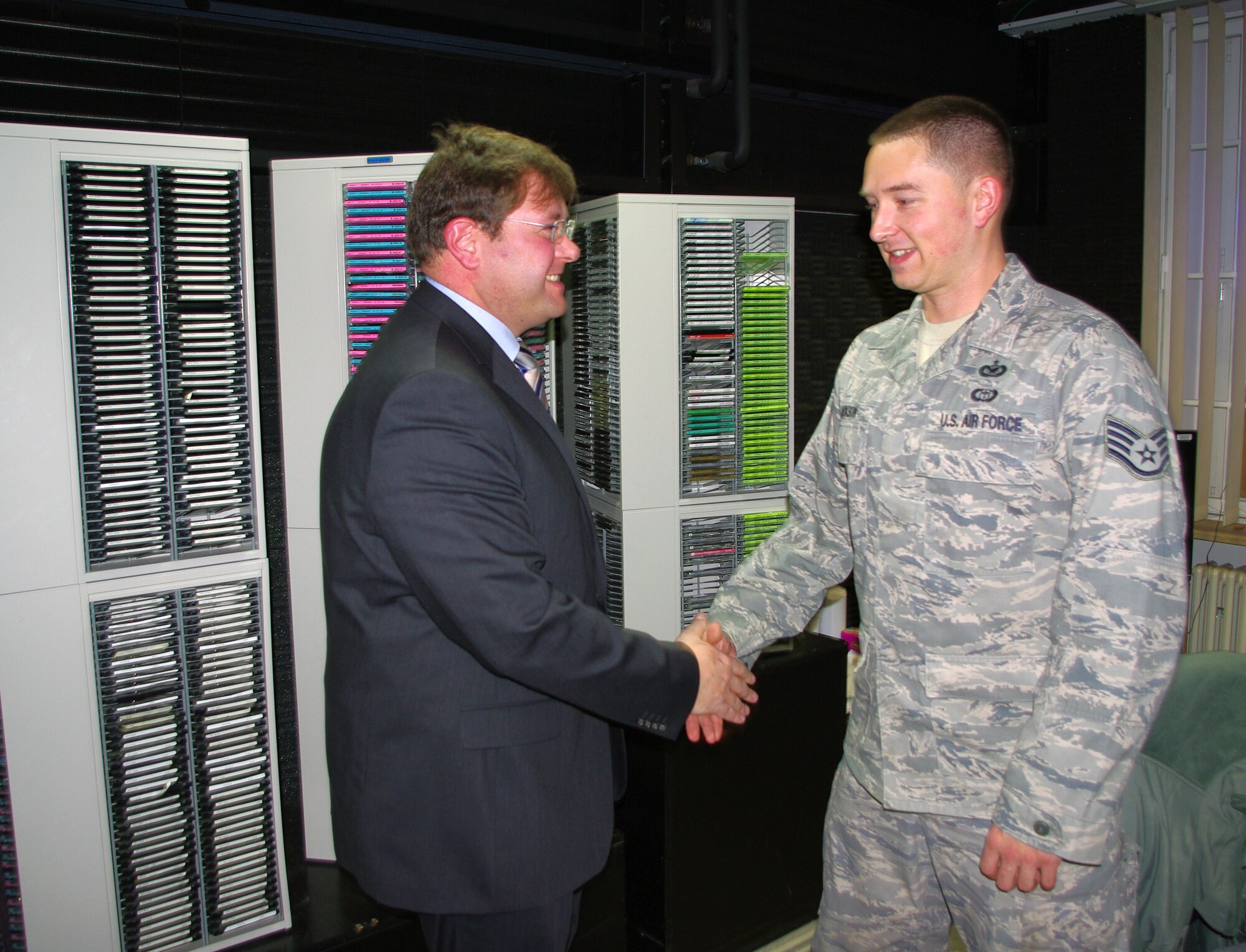 BITBURG, Germany -- Staff Sgt. Michael Jackson, American Forces Network-Spangdahlem broadcaster, shakes hands with Mr. Joachim Kandels, Bitburg mayor, following a Dec. 8 morning show. The mayor talked for about 30 minutes about events and activities in the Bitburg area. He emphasized  U.S. servicemembers and their families are always welcome. (U.S. Air Force photo/Iris Reiff)
