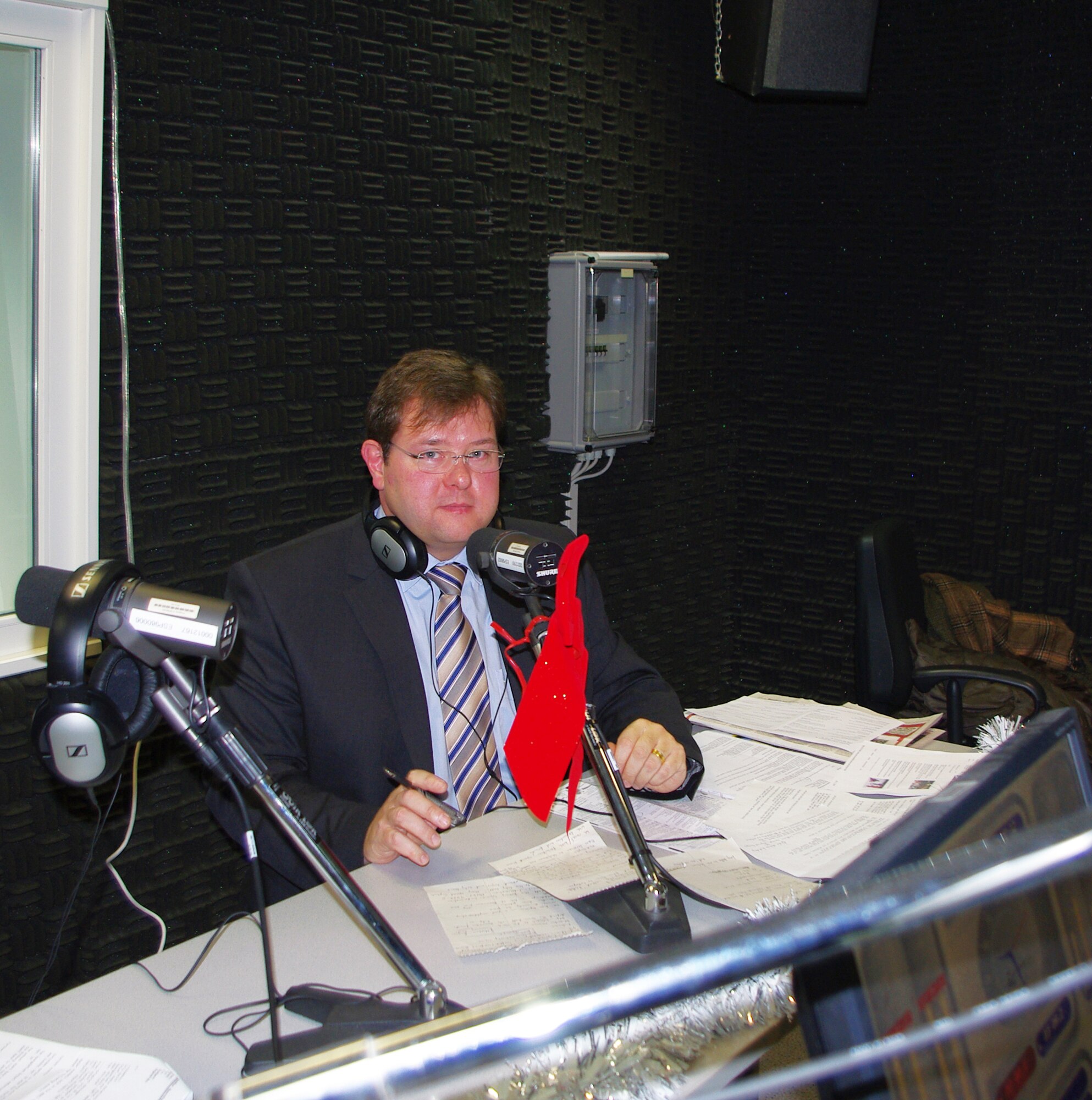 BITBURG, Germany -- Mr. Joachim Kandels, Bitburg mayor, receives a tour of the American Forces Network-Spangdahlem facility at the Bitburg French caserne area Dec. 8.  It was the first time he had visited the broadcasting station and addressed U.S. servicemembers and their families. He discussed events and activities in the Bitburg area. (U.S. Air Force photo/Iris Reiff)