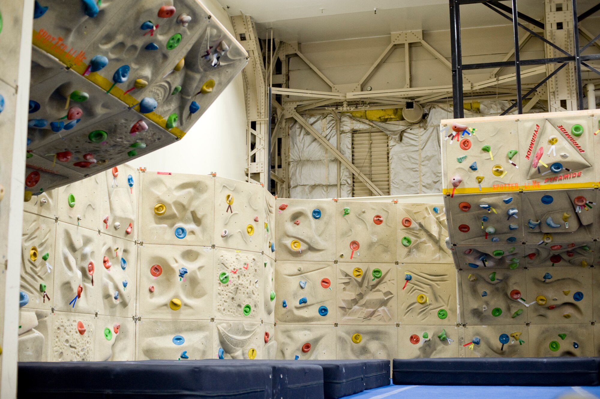 The Weasels’ Den at Misawa Air Base, Japan, offers a bouldering wall, which simulates climbing low rocks and boulders. The bouldering wall is lined with crash mats, so if the climber falls, he or she will not be injured. (U.S. Air Force photo by Airman James B. Bauer/Released)