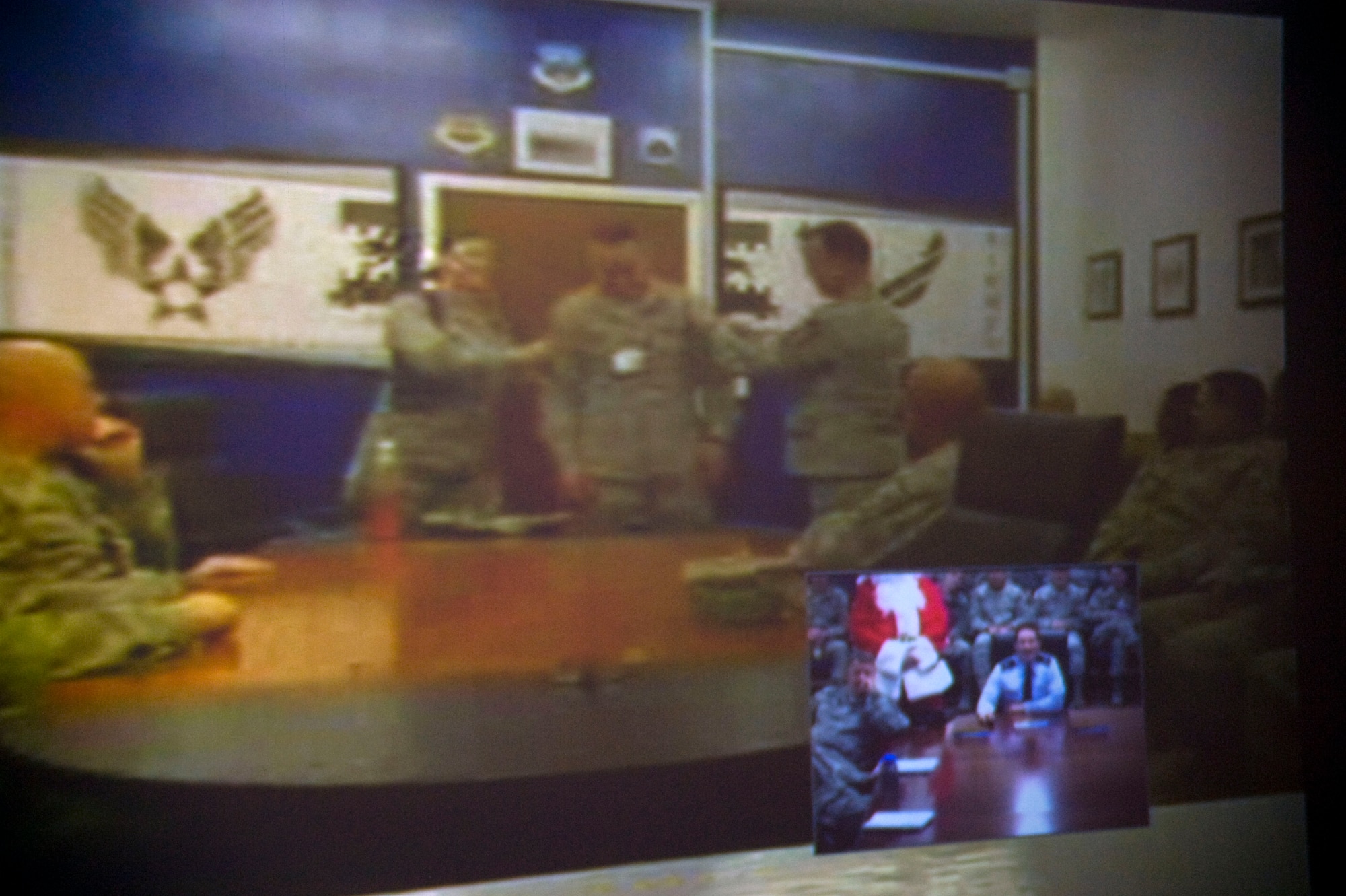 Tech Sgt. Jacob Davidson, 35th Aircraft Maintenance Squadron, receives master sergeant stripes from Col. Michael Rothstein, 35th Fighter Wing commander, Dec. 10, 2010, after a surprise STEP promotion announcement at Misawa Air Base, Japan via video teleconference. Staff Sgt. Vanessa Perner, 35th Communication Squadron and Staff Sgt. Carl Walker, 35th Maintenance Operations Squadron, also were STEP promoted. (U.S. Air Force photo by Tech Sgt. Russell McBride)