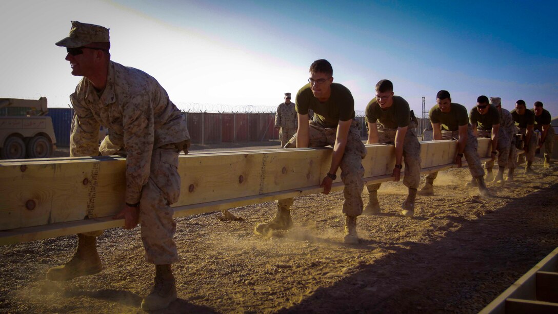 Marines with Combat Logistics Battalion 3, 1st Marine Logistics Group (Forward) help build the foundation of a combat operations center for Afghan National Army soldiers aboard Camp Garm-sher, Afghanistan, Dec. 10. The Marines are part of CLB-3's Embedded Partnering Team who are currently mentoring ANA soldiers to operate independent from coalition forces.