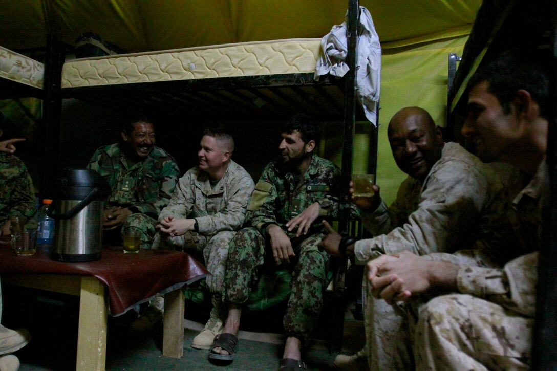 Marines with Combat Logistics Battalion 3, 1st Marine Logistics Group (Forward) and Afghan national army soldiers enjoy tea aboard Camp Garm-sher, Afghanistan, Dec. 10. The Marines are part of CLB-3's Embedded Partnering Team who are currently mentoring ANA soldiers to operate independent from coalition forces.