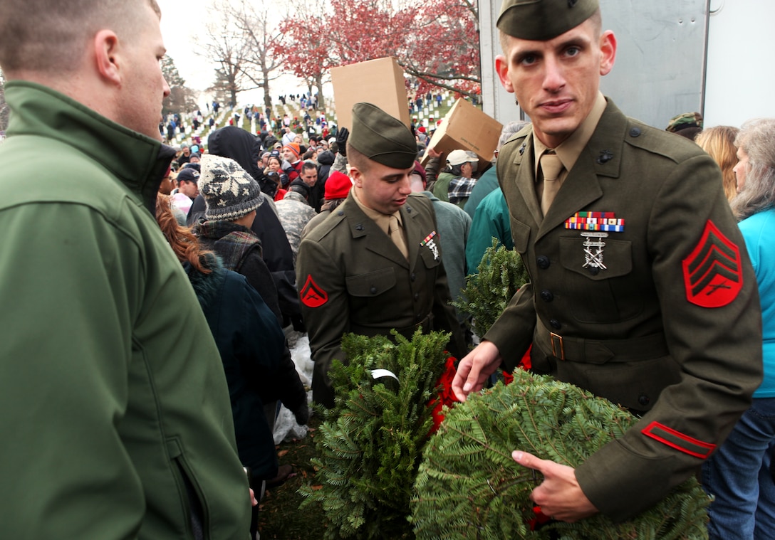 Marines from the Single Marine Program from Marine Corps Base Camp Lejeune make their way through a busy crowd of service members and families during a wreath laying ceremony at the Arlington National Cemetery, Dec. 11. The Thousands of participants in attendance helped lay approximately 24,000 wreaths this year, ensuring that those who gave the ultimate sacrifice fighting for the nation’s freedoms are not forgotten during the holidays.