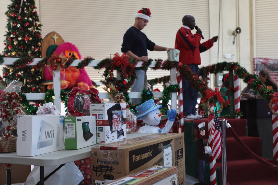 Wayne R. Bell, the I Marine Expeditionary Force (FWD) family readiness officer, reads raffle ticket numbers during a Christmas party hosted by the I MEF and MHG Family Readiness Office, Dec. 11. High Definition TVs, bicycles and video game systems were just a few of the prizes raffled off.