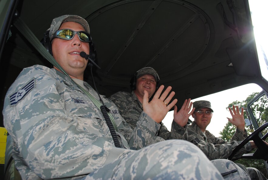 Staff Sgts. Robert Ludwig, Dusty Davidson and Aaron Legg ride in the third of a three vehicles from the 433rd Airlift Wing during the 29th Annual Guadalupe Street Parade, Sept. 18, 2010, in the Avenida neighborhood of San Antonio. Thirty Airmen from the Alamo Wing participated in the parade in observance of Hispanic Heritage Month which was observed from Sept. 15 through Oct. 15. (U.S. Air Force photo/Senior Airman Luis Loza Gutierrez)
