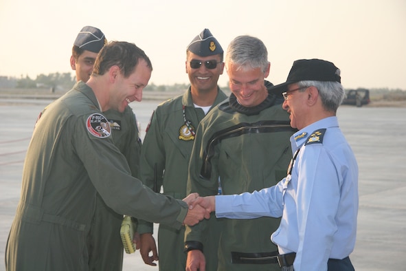Maj. Bart Van Roo shake shands with Air Marshal Mohammad Hassan, PAF Deputy  Chief of Staff for Operations on October 30, 2010, after delivering one of three new F-16s to the Pakistani Air Force.  Lt. Col. Doug Read (second from right) and Maj. Chris Hansen delivered two more F-16s the same day.
