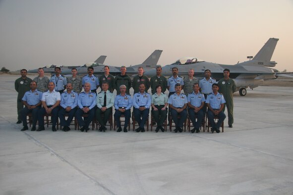Maj. Bart Van Roo, Lt. Col. Doug Read and Maj. Chris Hansen (back row, center), pose with officials from the Pakistani Air Force after delivering three new F-16s to Shahbaz AB on October 30, 2010.