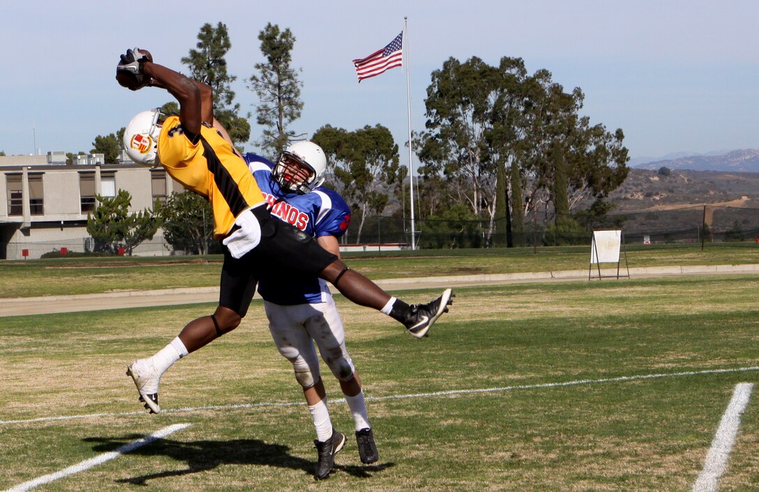 Jarvis Foster, with 1st Marine Logistics Group’s “Beasts” of Camp Pendleton, catches a football for the first touchdown of the “Best of the West” regional football championship at the 11 Area field, Dec. 11. The Best of the West has been won by a Marine Corps Air Ground Combat Center 29 Palms team since 2006; however, Camp Pendleton’s 1st MLG team prevailed this year and won the game 14-12.