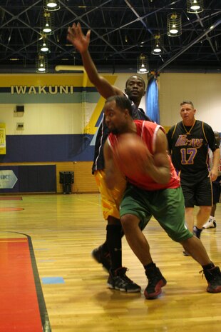 Courtney Simmons, Sho Stoppaz forward and center, evades Waner Bazile, Fil-Am point guard, in the championship game for the Holiday 2010 basketball tournament at IronWorks Gym here Sunday. This is the third consecutive tournament the Sho Stoppaz have won. The Sho Stoppaz were undefeated  throughout the tournament and beat Fil-Am 41-32 in the championship game.