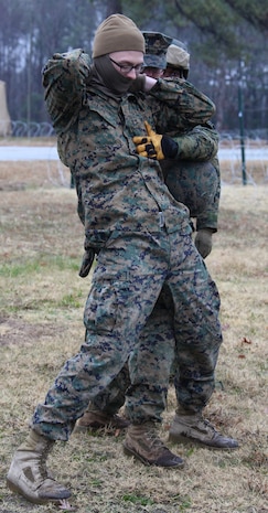 Sergeant Charles Griffeth, a heavy equipment operator and Rye, Colo., native, with Combat Logistics Battalion 22, 22nd Marine Expeditionary Unit, searches Pfc. Patrick W. Culleton, front, a field radio operator and San Angelo, Tx., native, with CLB 22, during a humanitarian assistance exercise aboard Fort Pickett, Va., Dec. 12, 2010.  The CLB participated in a two-week training exercise at Ft. Pickett, Va., in preparation for their upcoming deployment with the 22nd MEU in 2011.  The Marines and sailors of the 22nd MEU recently began an aggressive series of progressively, more complex pre-deployment exercises designed to train and test the MEU's ability to operate as a cohesive and effective fighting force.  The 22nd MEU is a multi-mission capable force of 2,200 Marines and sailors and comprised of Aviation Combat Element, Marine Tilt Rotor Squadron 263 (Reinforced); Logistics Combat Element, Combat Logistics Battalion 22; Ground Combat Element, Battalion Landing Team, 2nd Battalion, 2nd Marine Regiment; and its command element.