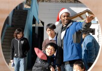 KUNSAN AIR BASE, Republic of Korea -- Senior Airman Lawrence O'neal, 8th Medical Operations Squadron, facilitates a bean bag throwing contest at the the Il Mag Won orphanage Dec. 11.  Airman O'neal and other Wolf Pack members from the base chapel coordinated a holiday party for the children at the orphanage, where volunteers donated time, gifts, food and more to the children.  (U.S. Air Force photo/Capt. Sheryll Klinkel)