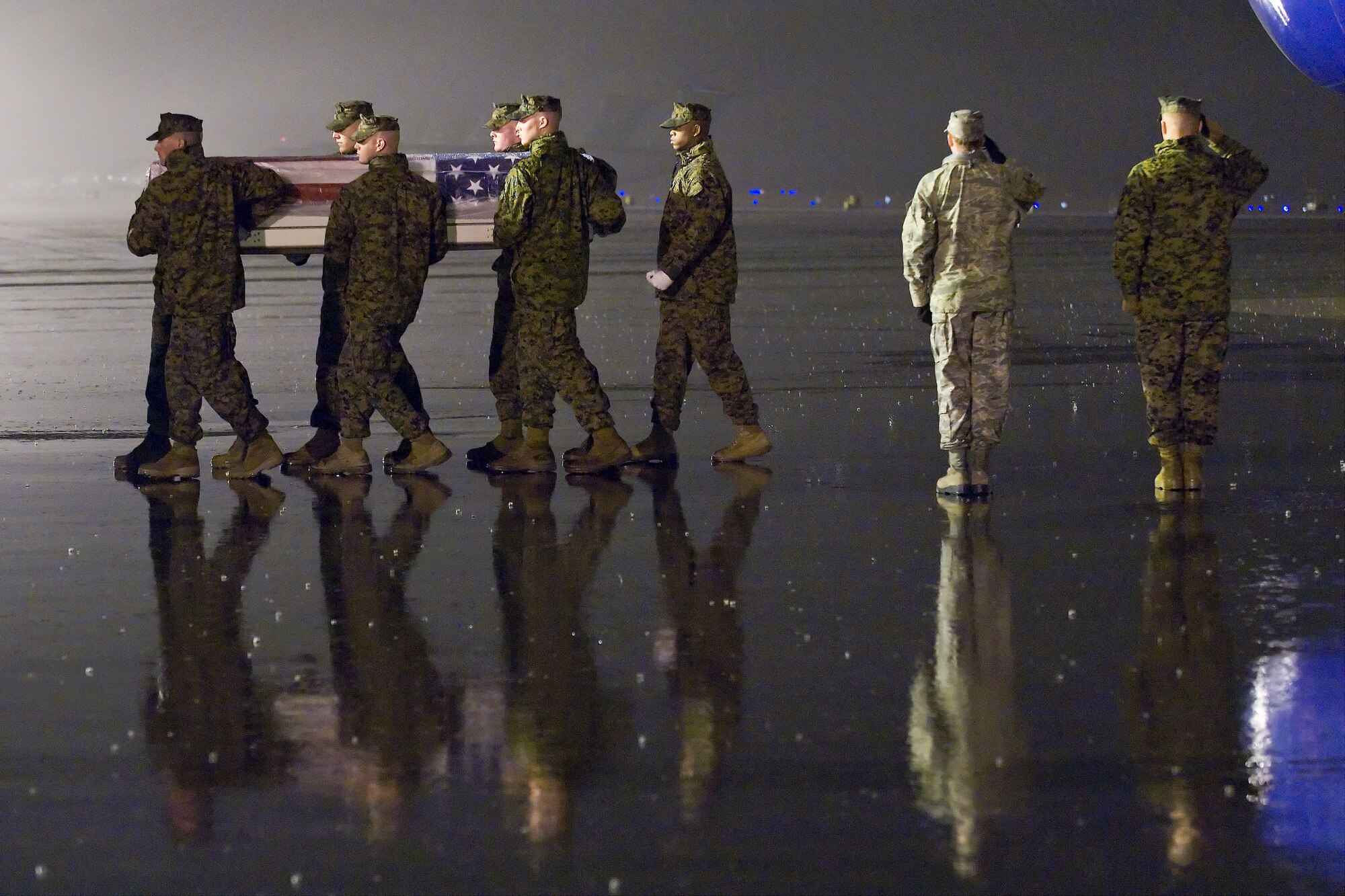 A U.S. Marine Corps carry team transfers the remains of Marine Staff Sgt. Stacy A. Green, of Alexander City, Ala., at Dover Air Force Base, Del., Dec. 12, 2010. Green was assigned to the 1st Battalion, 8th Marine Regiment, 1st Marine Division, I Marine Expeditionary Force, Camp Pendleton, Calif.  (U.S. Air Force photo/Roland Balik)