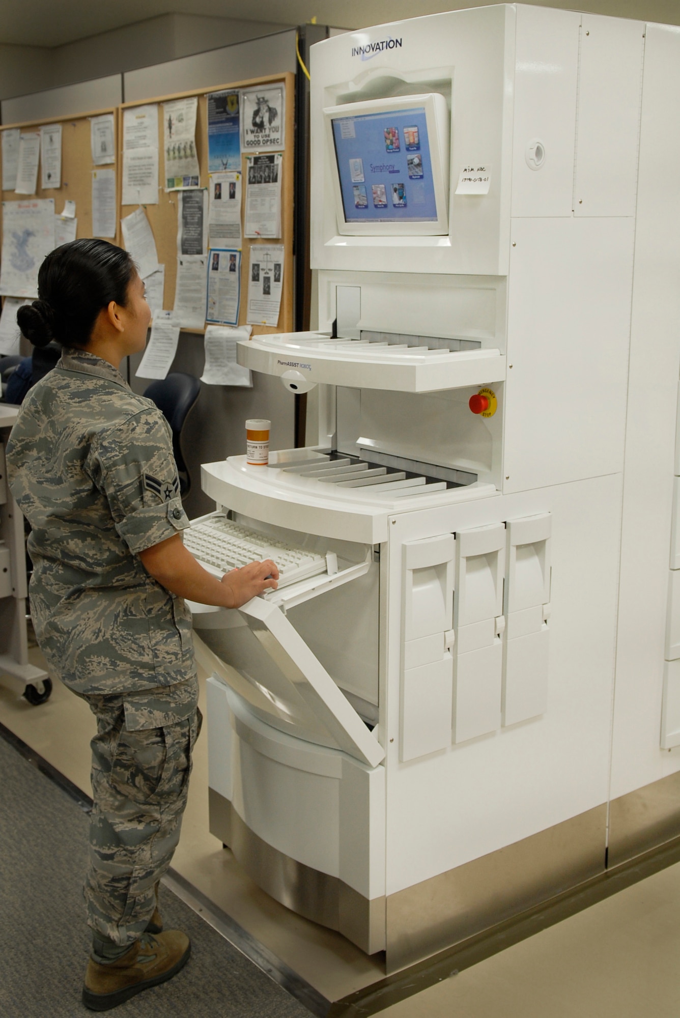 Airman 1st Class Roma Terry, a pharmacy technician with the 18th Medical Support Squadron, begins running a check on the new pharmacy robot. The PharmASSIST ROBOTx has established quality checkpoints throughout the pharmacy by employing bar code scanning, digital images of medications and original paper prescriptions, and protocols at every stage of the prescription filling process. (U.S. Air Force photo/ Airman 1st Class Tara A. Williamson)