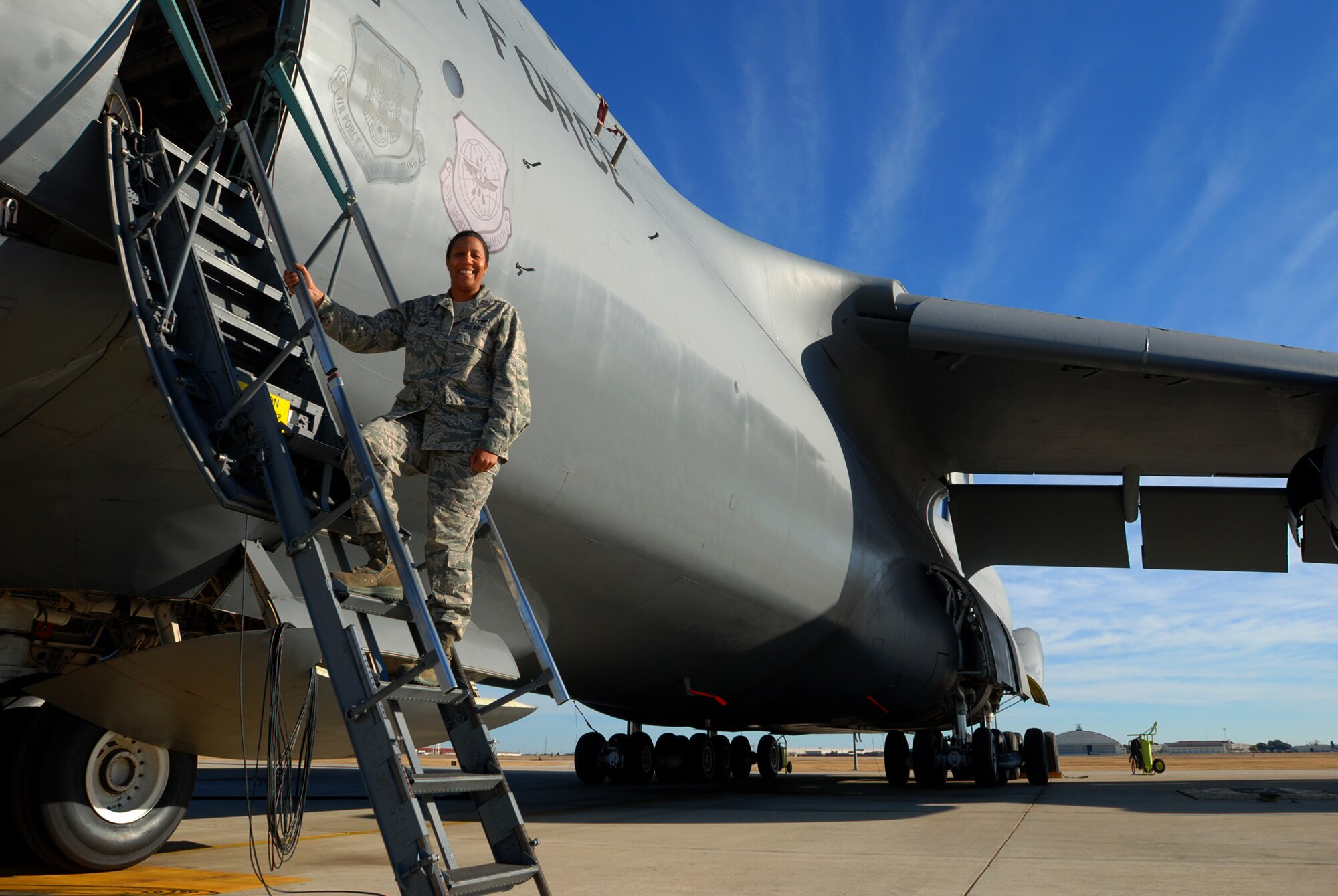Capt. Jenny Martin, 433rd Aircraft Maintenance Squadron, stands on the ladder of a C-5A Galaxy cargo aircraft at Lackland Air Force Base, Texas. Captain Martin is the 2010 recipient of the Lt. Gen. Leo Marquez award. (U.S. Air Force photo/Airman 1st Class Brian McGloin)