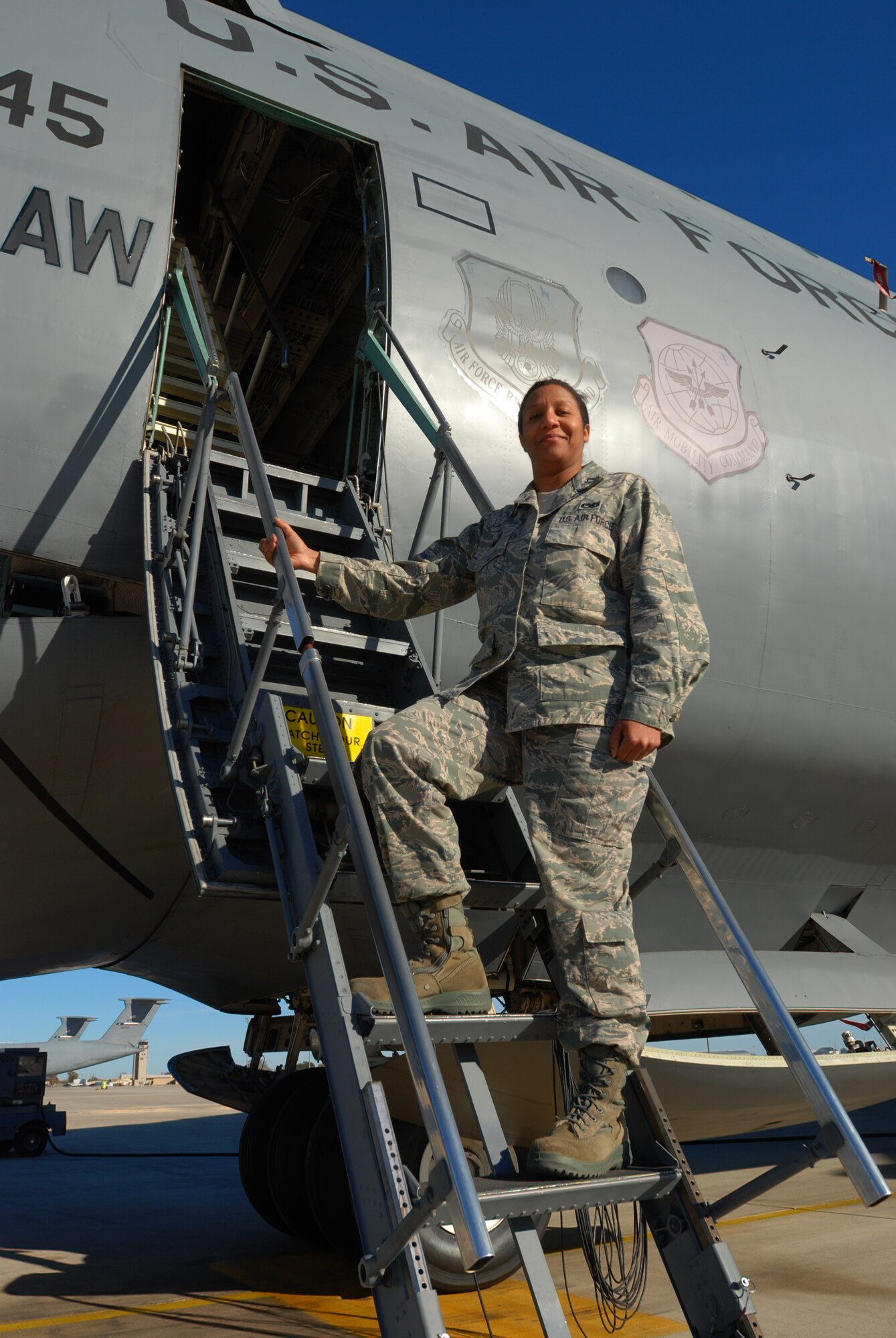 Capt. Jenny Martin, 433rd Aircraft Maintenance Squadron stands on the ladder of a C-5A Galaxy cargo aircraft at Lackland Air Force Base, Texas. Captain Martin is the 2010 recipient of the Lt. Gen. Leo Marquez award. (U.S. Air Force photo/Airman 1st Class Brian McGloin)