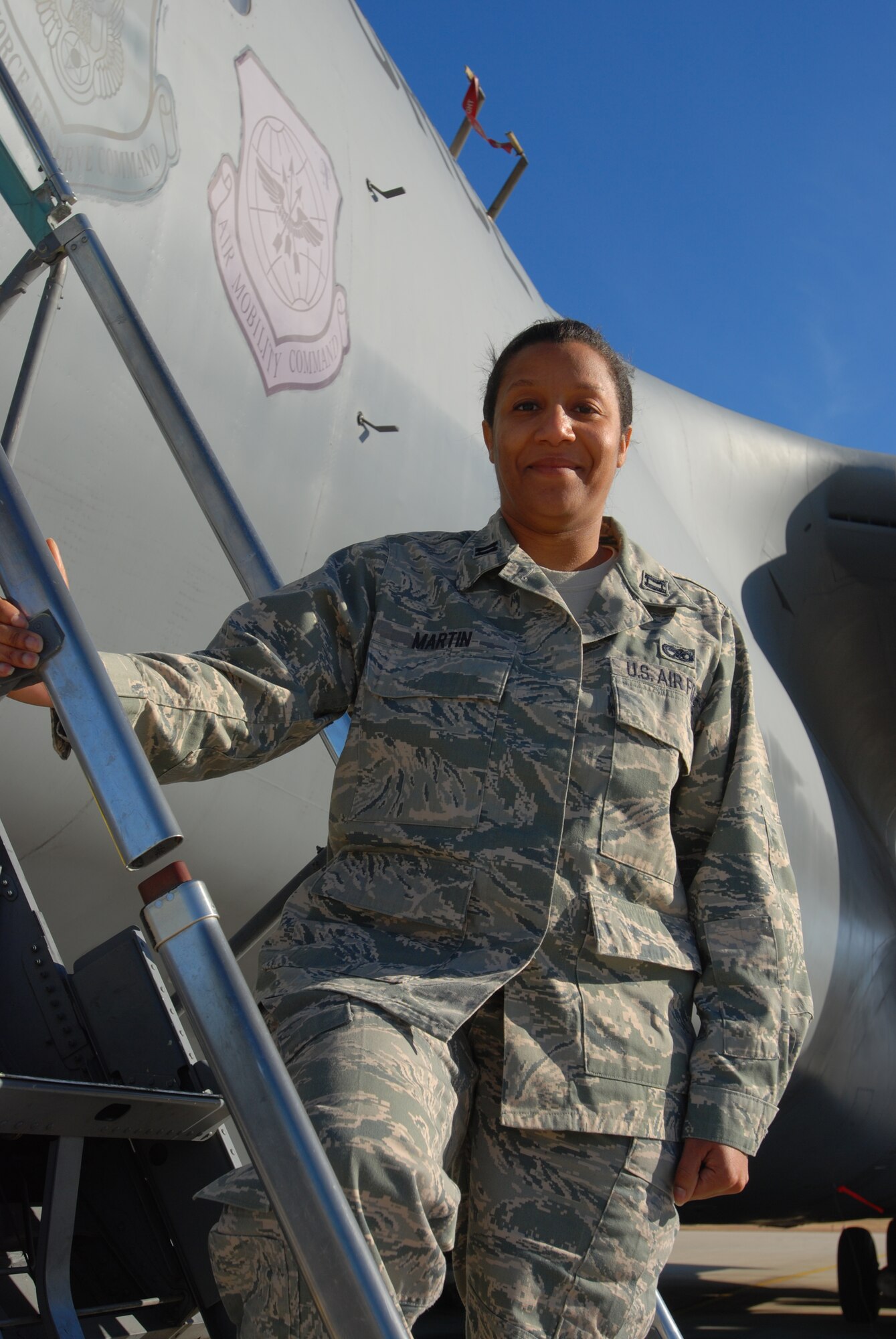 Capt. Jenny Martin, 433rd Aircraft Maintenance Squadron stands on the ladder of a C-5A Galaxy cargo aircraft at Lackland Air Force Base, Texas. Captain Martin is the 2010 recipient of the Lt. Gen. Leo Marquez award. (U.S. Air Force photo/Airman 1st Class Brian McGloin)