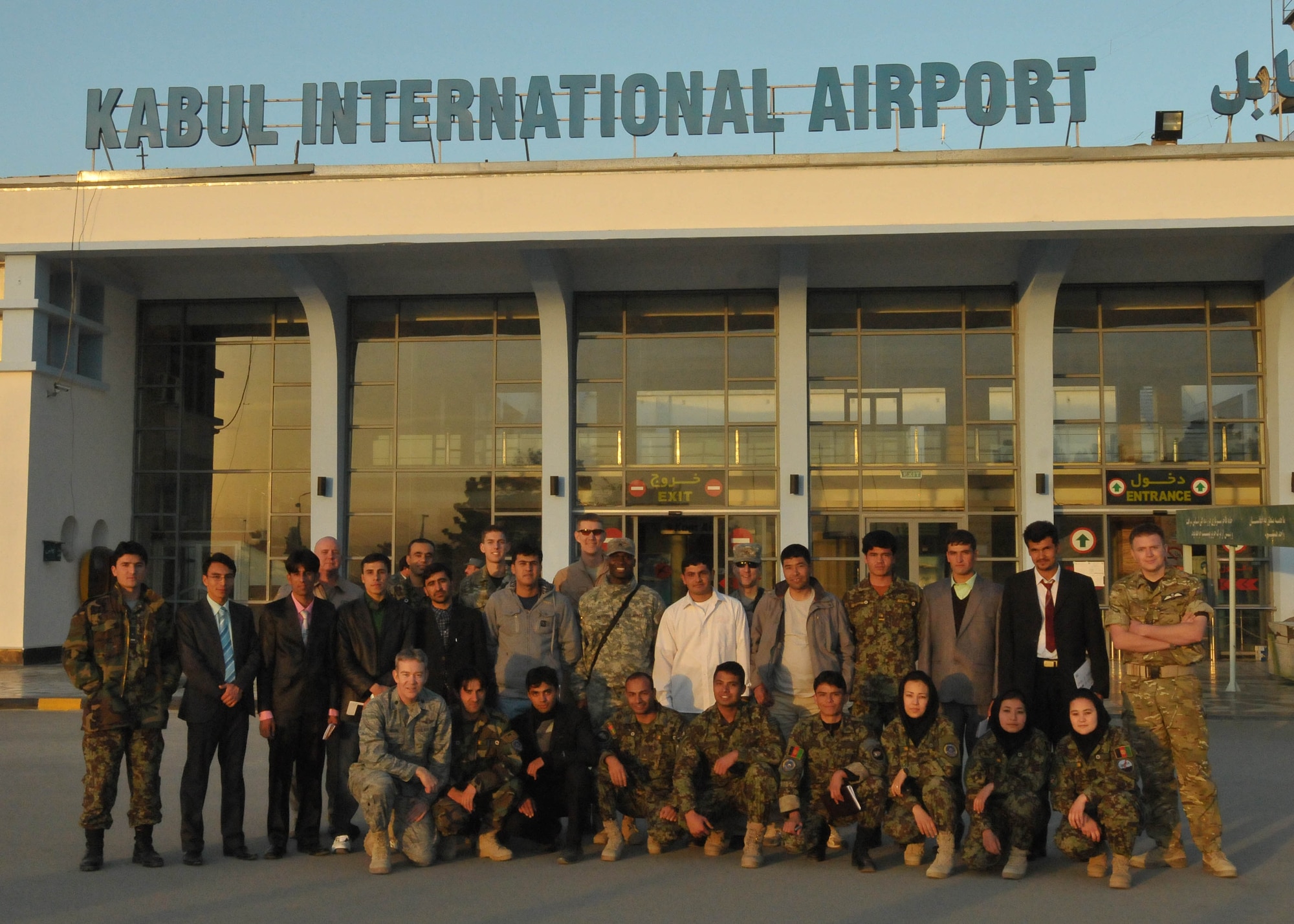 101211-N-6541W-033 KABUL, Afghanistan - Members of the Afghan Air Force who are leaving to go to a partner nation in the middle east for pilot and English training pose for a photo with their advisors and fellow students at Kabul International Airport, on Dec. 11th.  (U.S. Navy photo by Mass Communication Specialist 3rd Class Jared Walker/ RELEASED).