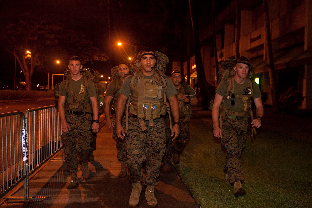 Under the auburn glow of Honolulu streetlights, eight Marines in boots and camouflage trousers donned packs chock-full of fluids, food and 65 pounds of gear made their way to the starting line at the 2010 Honolulu Marathon, Dec. 12, 2010. For the second year in a row, the Marines, primarily from Aircraft Rescue Firefighting, Marine Corps Air Station Kaneohe Bay, Hawaii, hiked the 26.3-mile marathon to raise money for wounded Marines and sailors at Wounded Warrior Battalion West — Detachment Hawaii. “At first, people looked at us like we were crazy,” said Chicago native Sgt. Fernando Camacho, a firefighter with ARFF. “But when they realized why were hiking — to help out those who couldn’t because of the pain they had endured — the looks on their faces changed. That made it well worth it.”