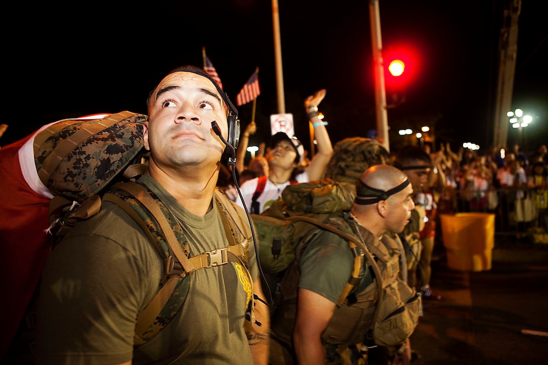 In front of a sea of more than 22,000 competitors, Sgt. Fernando Camacho, a firefighter with Aircraft Rescue Firefighting, Marine Corps Air Station Kaneohe Bay, Hawaii, and fellow Marines wait for the beginning of the 2010 Honolulu Marathon at its starting line, Dec. 12, 2010. For the second year in a row, the Marines, primarily from ARFF, hiked the 26.3-mile marathon with boots, camouflage trousers and 65-pound packs to raise money for wounded Marines and sailors at Wounded Warrior Battalion West — Detachment Hawaii. “At first, people looked at us like we were crazy,” said Camacho, from Chicago. “But when they realized why were hiking — to help out those who couldn’t because of the pain they had endured — the looks on their faces changed. That made it well worth it.”