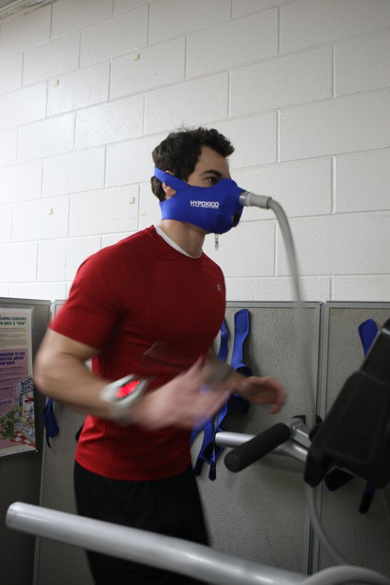 MARINE CORPS BASE CAMP LEJEUNE, N.C. - Arthur Hill, a personal trainer with the French Creek Fitness Center, demonstrates how the Hypoxico High Altitude Training system works when operating a piece of workout equipment, Dec. 13. The Hypoxico unit regulates the amount of oxygen intake to an individual when working out to simulate exercising in high altitudes. (Official U.S. Marine Corps photo by Lance Cpl. Jonathan G. Wright)