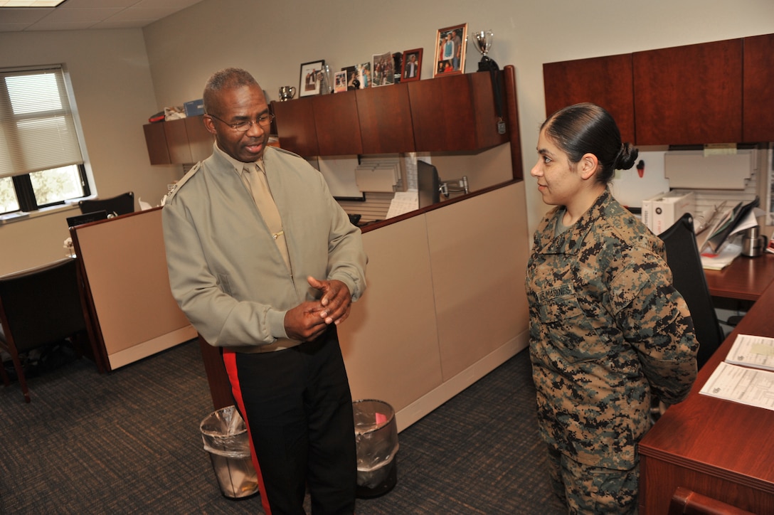 Maj. Gen. Ronald L. Bailey, commanding general of the Western Recruiting Region, speaks with Sgt. Yadira Z. Mendoza, 8th Marine Corps District Contact Team clerk, during his visit to the district headquarters Dec. 13, 2010. Bailey spoke one-on-one with headquarters Marines before continuing his tour around the district's area of responsibilty.