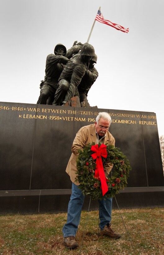 James Donovan, excecutive director of the Marine War Memorial Foundation, lays a wreath during the 1st Marine War Memorial Christmas wreath laying ceremony December 13, 2010.